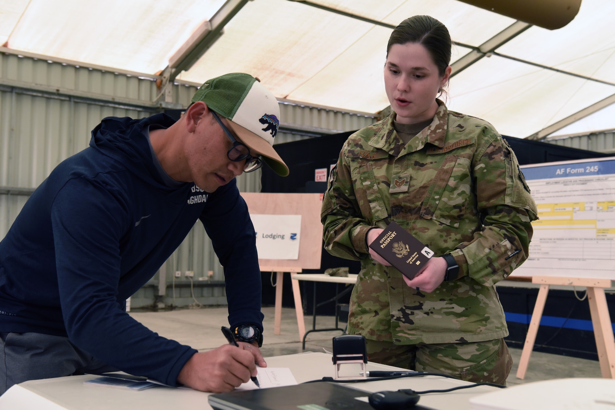 Staff Sgt. Samantha Rak, 380th Air Expeditionary Wing Host Nation Coordination Office immigrations technician, verifies the paperwork of an inbound member at Al Dhafra Air Base, United Arab Emirates, Mar. 5, 2019.