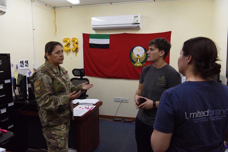 Senior Master Sgt. Margarita Jimenez, 380th Air Expeditionary Wing Host Nation Coordination Office superintendent, answer passport questions from inbound members at Al Dhafra Air Base, United Arab Emirates, Mar. 8, 2019.