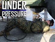 U.S. Marine Corps Lance Cpl. Audie Rooks pressure washes the underside of a backhoe March 13, 2019 on Camp Kinser, Okinawa, Japan. The backhoe is one of many pieces of equipment that are cleaned, inspected and then shipped for use in Australia by the Marine Rotational Force – Darwin Marine Air-Ground Task Force. Rooks, a heavy equipment operator with Heavy Equipment Operations Platoon, Engineer Support Company, 9th Engineer Support Battalion, 3rd Marine Logistics Group, is a native of Hawkinsville, Georgia. (U.S. Marine Corps photo by Cpl. Isabella Ortega)