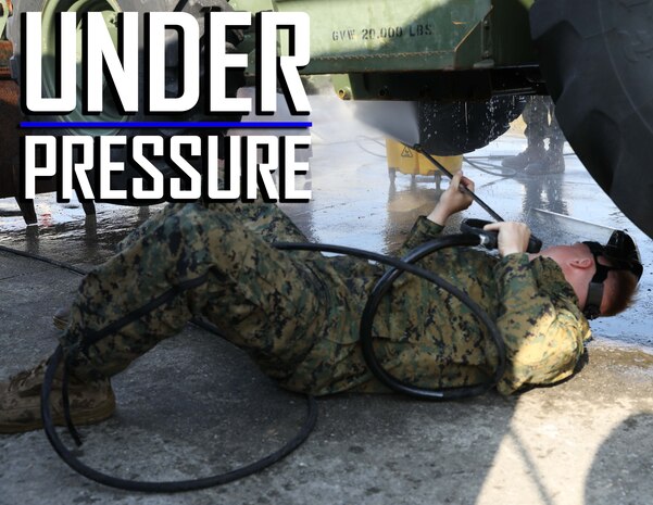 U.S. Marine Corps Lance Cpl. Audie Rooks pressure washes the underside of a backhoe March 13, 2019 on Camp Kinser, Okinawa, Japan. The backhoe is one of many pieces of equipment that are cleaned, inspected and then shipped for use in Australia by the Marine Rotational Force – Darwin Marine Air-Ground Task Force. Rooks, a heavy equipment operator with Heavy Equipment Operations Platoon, Engineer Support Company, 9th Engineer Support Battalion, 3rd Marine Logistics Group, is a native of Hawkinsville, Georgia. (U.S. Marine Corps photo by Cpl. Isabella Ortega)