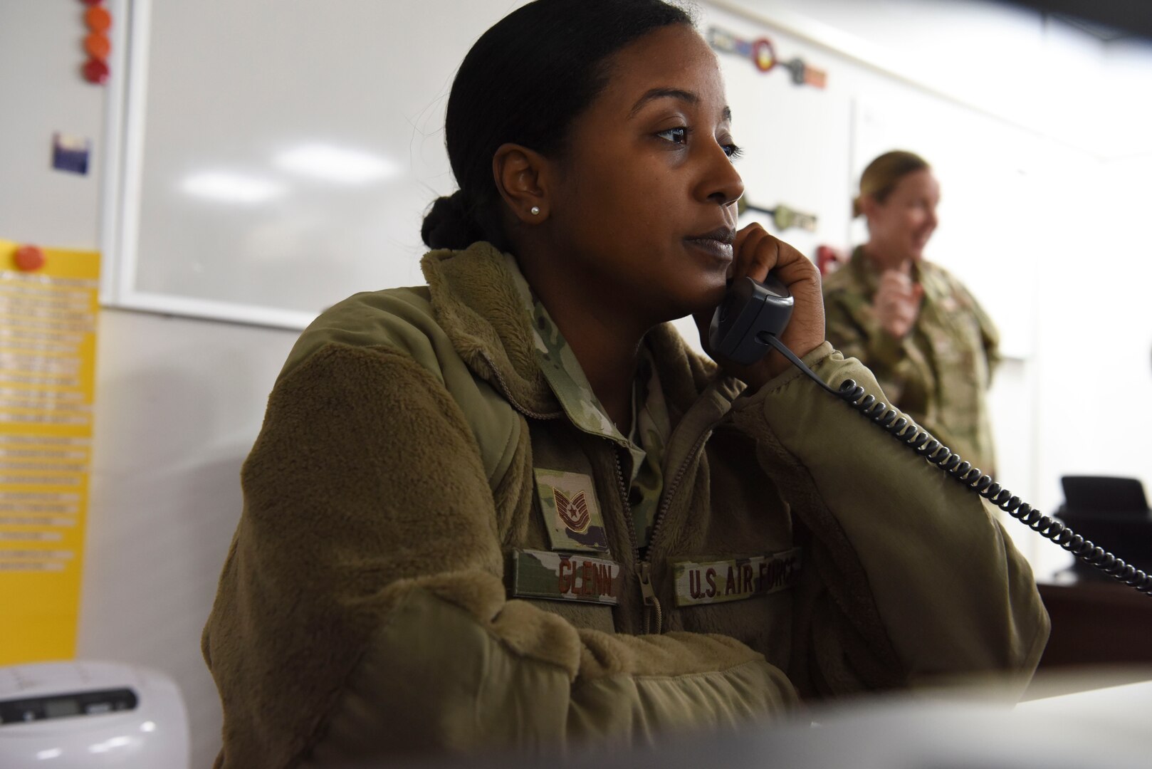 Tech. Sgt. Kathryn Glenn, 380th Expeditionary Logistics Readiness Squadron NCOIC, logistics plans, answers a call about redeployments at Al Dhafra Air Base, United Arab Emirates, Mar. 14, 2019.