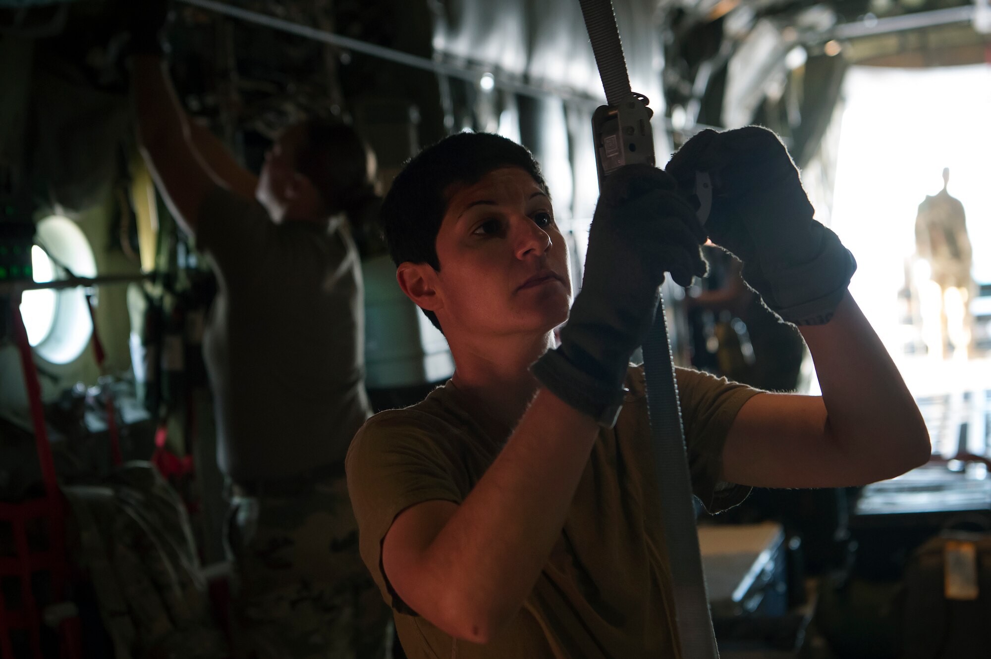 Capt. Sandra Mandell, 379th Expeditionary Aeromedical Evacuation Squadron (EAES) flight nurse, fastens a device used to store medical equipment on a C-130 Hercules at Al Udeid Air Base, Qatar, before a recent aeromedical evacuation mission.