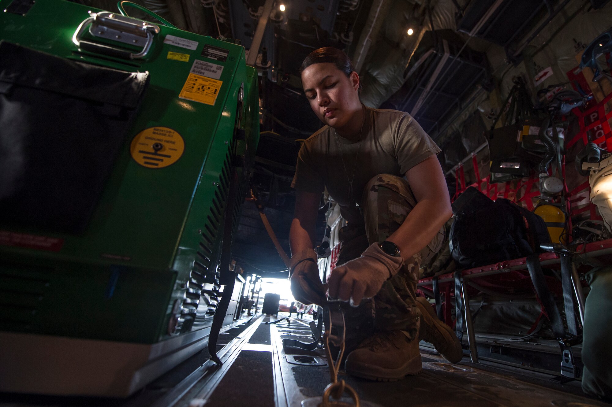 Staff Sgt. Jessica Hakert, 379th Expeditionary Aeromedical Evacuation Squadron (EAES) aeromedical evacuation technician, fastens medical equipment to a C-130 Hercules at Al Udeid Air Base, Qatar, before a recent aeromedical evacuation mission.