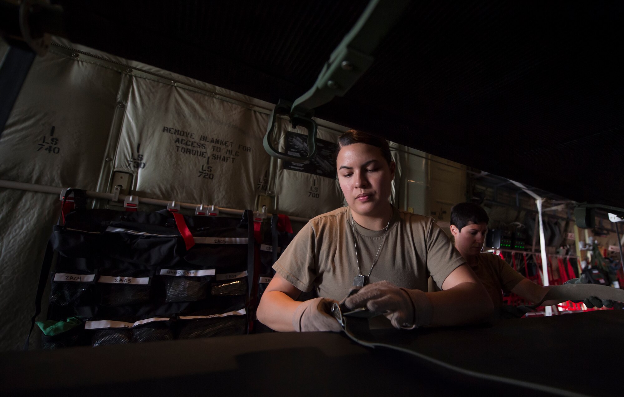 Staff Sgt. Jessica Hakert, 379th Expeditionary Aeromedical Evacuation Squadron (EAES) aeromedical evacuation technician, prepares a litter for transport on a C-130 Hercules at Al Udeid Air Base, Qatar, before a recent aeromedical evacuation mission.