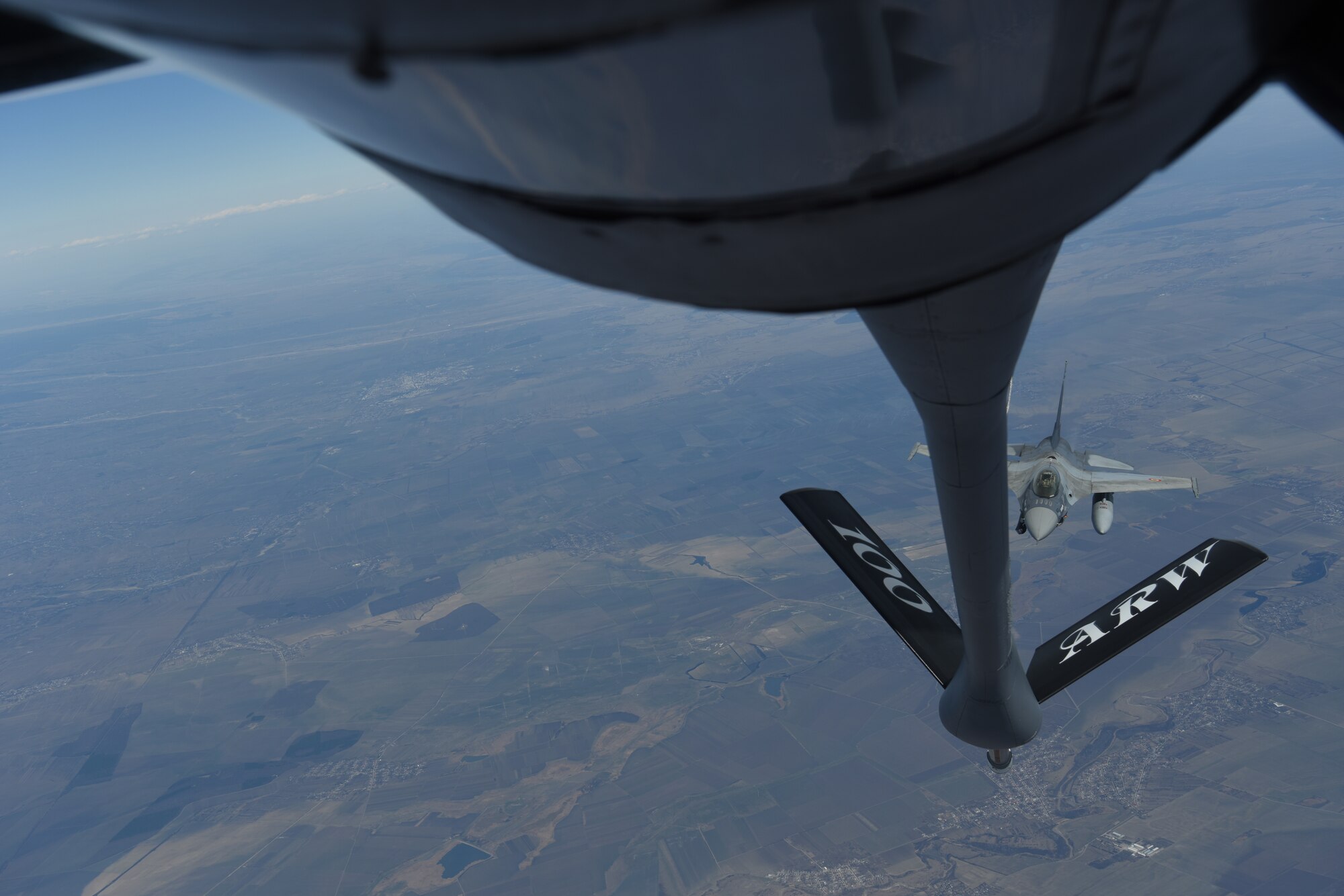 A Romanian air force F-16 prepares to receive fuel from a KC-135 Stratotanker from RAF Mildenhall, England during training over the skies of Romania, March 11, 2019. The training was an example of U.S. and NATO allies sharing a commitment to promote peace and stability through developing their relationship and communication process. (U.S. Air Force photo by Airman 1st Class Brandon Esau)