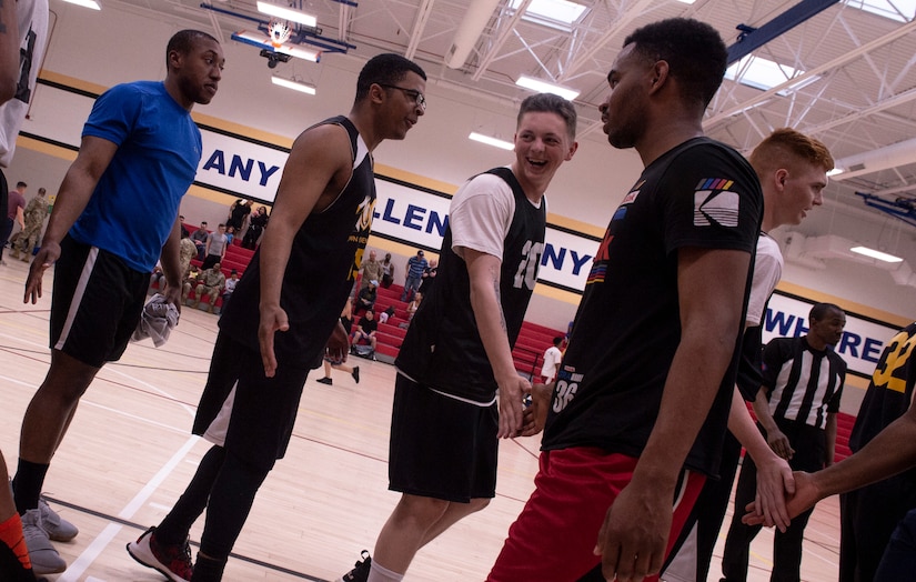 U.S. Airmen and Soldiers congratulate each other following the completion of an intramural basketball championship game at Shaw Air Force Base, S.C., March 14, 2019.