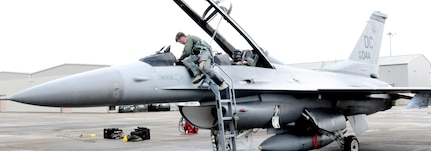 113th Wing pilot Capt. Matthew Morris prepares for an F-16C training flight at Naval Air Station Joint Reserve Base New Orleans. The D.C. Air National Guard Airmen are participating in a two-week flying exercise titled Sentry Voodoo in New Orleans.