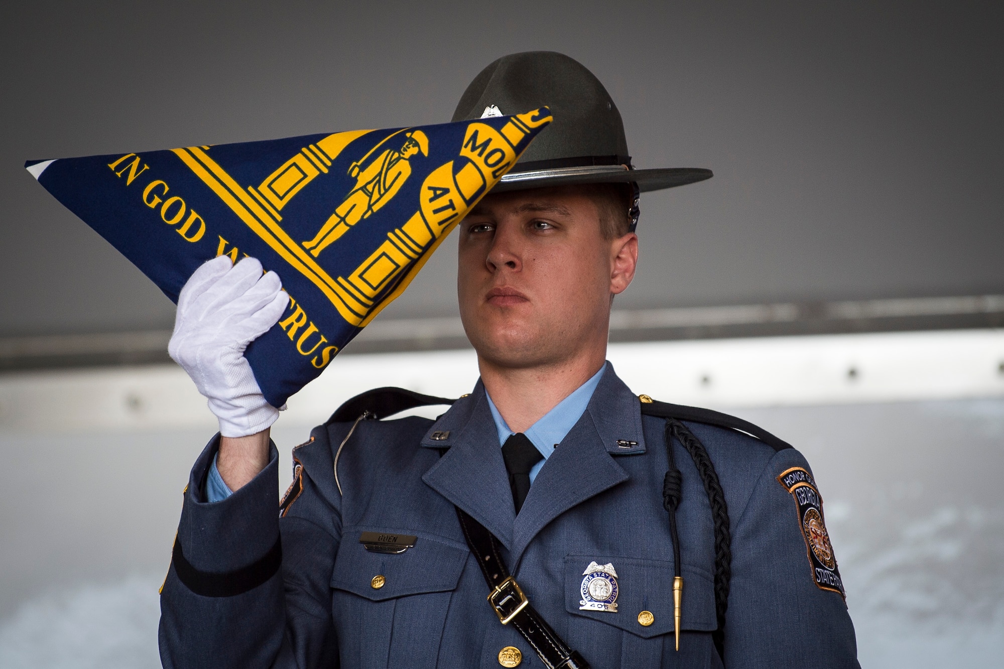 A Georgia State Patrol detail folds a Georgia State flag to the Greene family during the Celebration of Life ceremony honoring the late Mr. W. Parker Greene, March 14, 2019, at Moody Air Force Base, Ga. Greene, a steadfast Air Force advocate and one of the most influential military civic leaders passed away Dec. 18, 2018. (U.S. Air Force Photo by Senior Airman Janiqua P. Robinson)