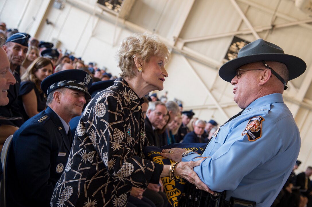 Georgia State Patrol Col. Mark McDonough, Department of Public Safety commissioner, presents a Georgia State flag to Dr. Lucy Greene during the Celebration of Life ceremony honoring the late Mr. W. Parker Greene, March 14, 2019, at Moody Air Force Base, Ga. Greene, a steadfast Air Force advocate and one of the most influential military civic leaders passed away Dec. 18, 2018. (U.S. Air Force Photo by Andrea Jenkins)
