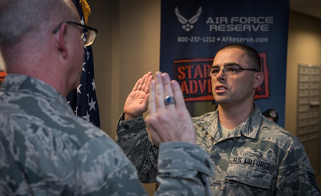 Staff. Sgt. Donovan Klein, new addition to the Air Force Reserve Recruiting services, recites the oath of enlistment given to him on Mar. 13, 2019 by Lt. Col. Stan Paregien, 932nd Airlift Wing Public Affairs Officer, during a reenlistment ceremony at the 932nd AW Headquarters building, Scott Air Force Base, Illinois. Klein adds to his adventure when he starts helping new citizen Airmen begin their own Air Force adventures in Wichita, Kansas. "I'm excited for this opportunity, but will miss my 932nd family," said Klein.  (U.S. Air Force photo by Christopher Parr)
