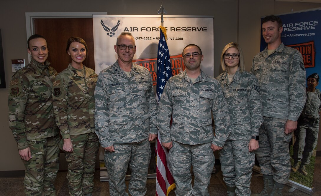 Staff. Sgt. Donovan Klein, new Air Force Reserve recruiter, stands with Lt. Col. Stan Paregien, 932nd Airlift Wing Public Affairs Officer, and fellow Air Force recruiters following Klein’s reenlistment ceremony at the 932nd AW Headquarters building, Scott Air Force Base, Illinois. Klein said he gained a lot of knowledge from attending the second total force recruiters class to be taught with active duty, Reserve and Guard.  He looks forward to contributing to the greater Air Force by helping new citizen Airmen, near McConnell AFB, begin their Air Force adventures.  (U.S. Air Force photo by Christopher Parr)