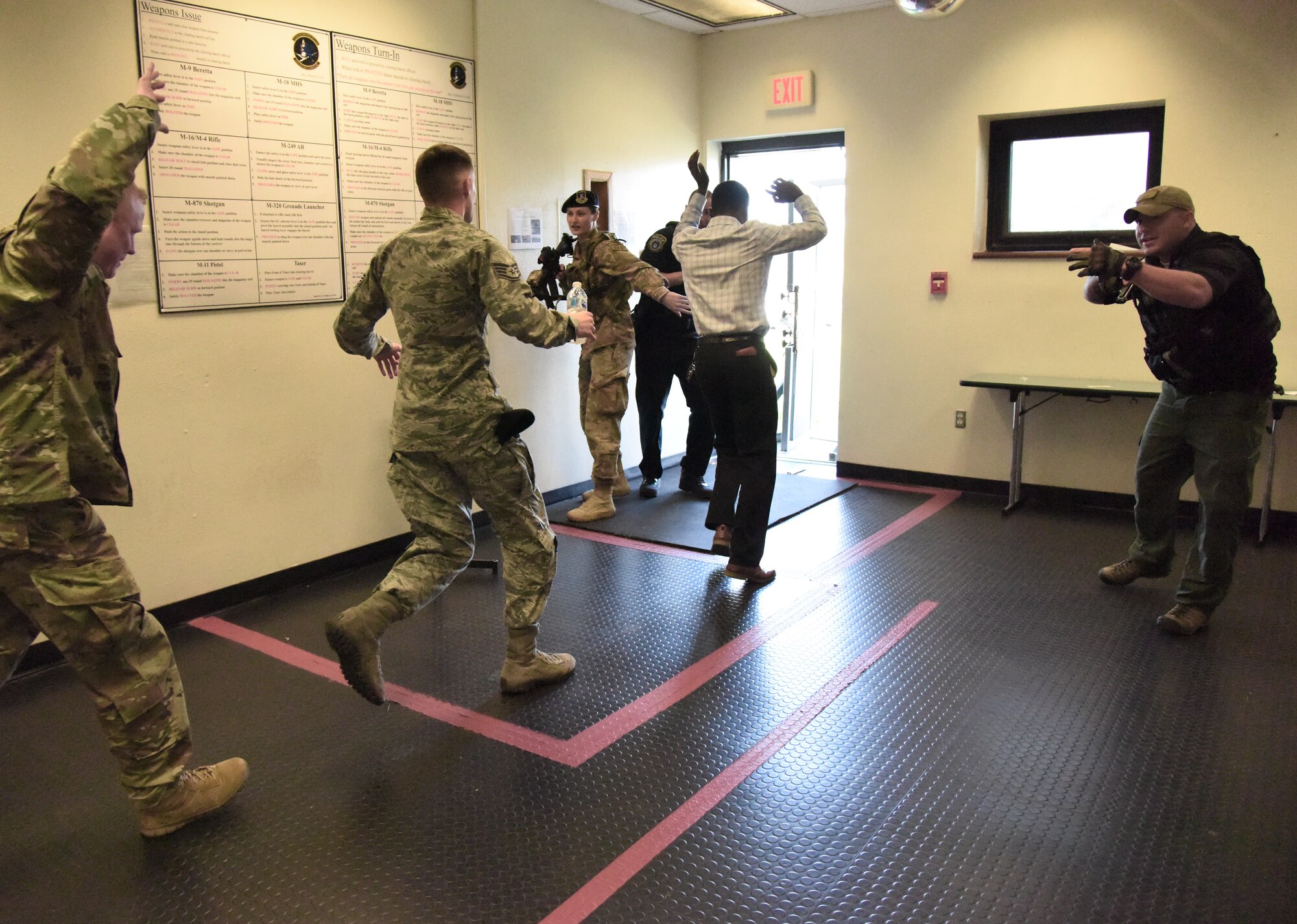 Keesler personnel run for safety as members of the 81st Security Forces Squadron enter the building during an 81st SFS active shooter training demonstration at Keesler Air Force Base, Mississippi, March 14, 2019. The scenario included a disgruntled Airman with marital problems and a pending administrative discharge who ran the entry gate which then escalated to an active shooter situation. Leadership attended the event, which is one of several in recognition of the Year Of The Defender, to observe what steps Keesler Defenders take during a high intensity situation, such as an active shooter, in preparation for real-world situations. U.S. Air Force Tech. Sgt. Anthony Horton, 81st SFS training NCO in charge, said that the demonstration provided defenders with a realistic scenario that encompassed baseline first responder skills and effectively breeds multi-agency cooperation toward the common goal of minimizing casualties and neutralizing the threat expeditiously. (U.S. Air Force photo by Kemberly Groue)