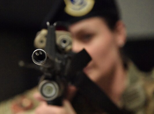 U.S. Air Force Staff Sgt. Emily Arceneaux, 81st Security Forces Squadron police services NCO in charge, aims her weapon towards the room where the "shooter" has barricaded himself during an 81st SFS active shooter training demonstration at Keesler Air Force Base, Mississippi, March 14, 2019. The scenario included a disgruntled Airman with marital problems and a pending administrative discharge who ran the entry gate which then escalated to an active shooter situation. Leadership attended the event, which is one of several in recognition of the Year Of The Defender, to observe what steps Keesler Defenders take during a high intensity situation, such as an active shooter, in preparation for real-world situations. (U.S. Air Force photo by Kemberly Groue)