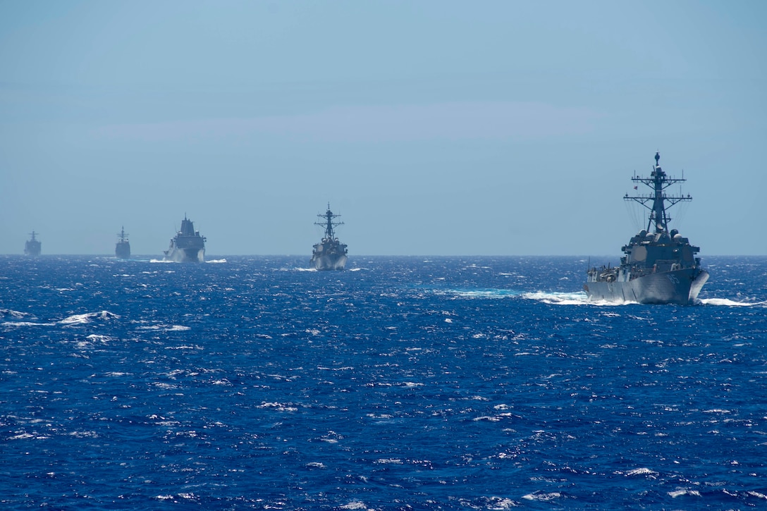 Five military ships operate together in the Philippine Sea.