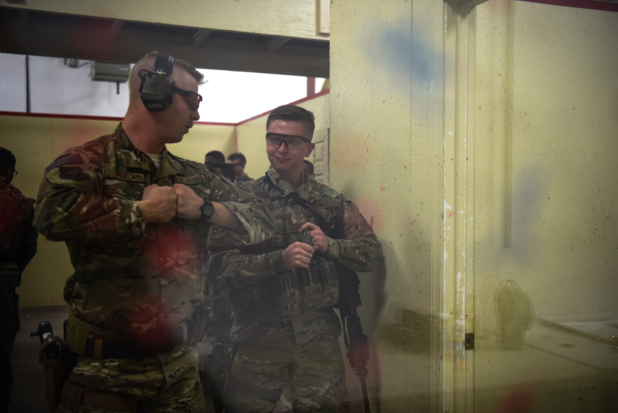 An Airman receives a demonstration on the proper use of an M84 flashbang during a response force tactical course Mar. 27, 2019, at the 90th Ground Combat Training Squadron, Camp Guernsey, Wyo. This distractionary device is a less than lethal ammunition grenade that helps to distract and cause chaos and allows security forces to make it through the door safely and gain control of a situation. (U.S. Air Force photo by Senior Airman Abbigayle Williams)