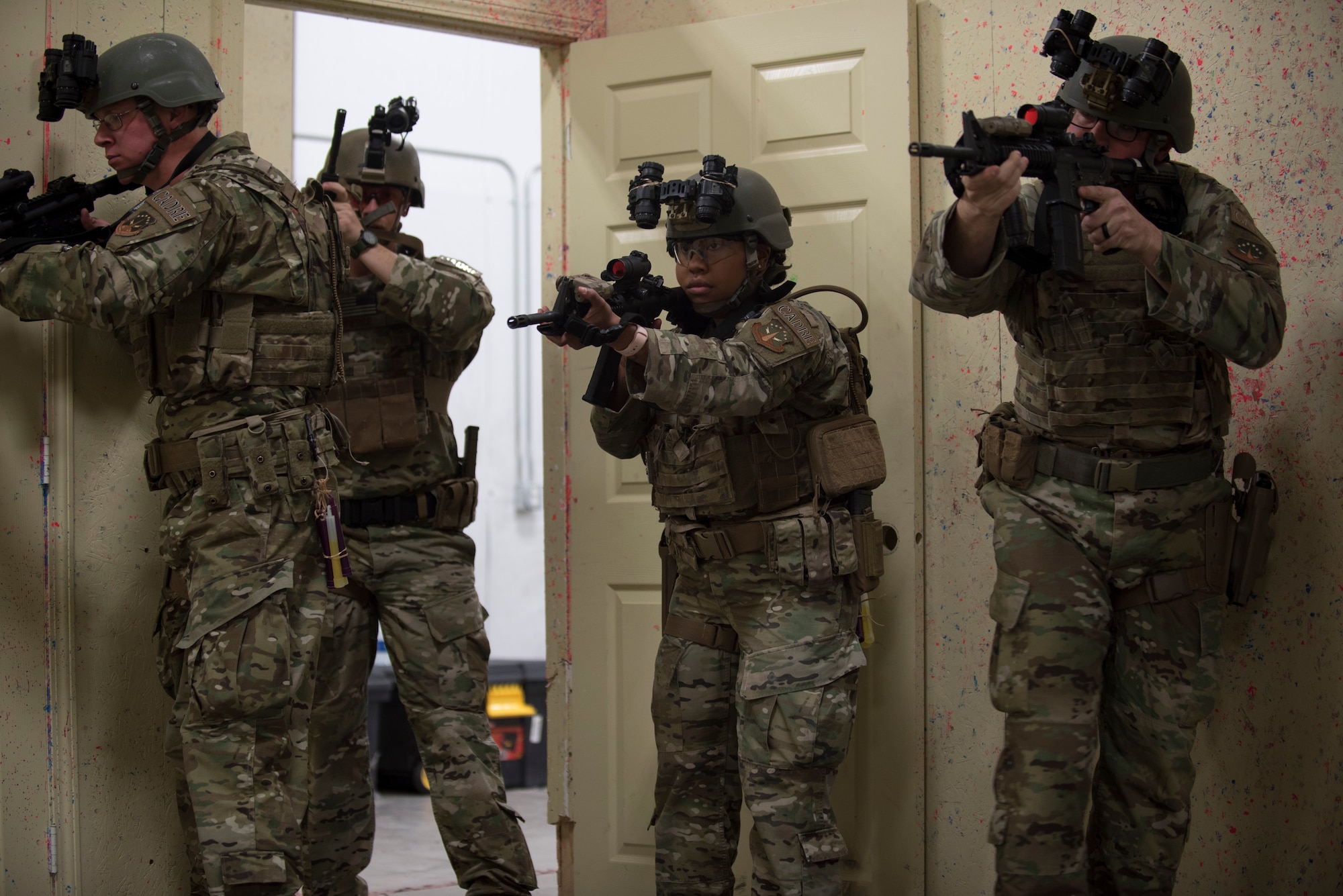 The response force tactical course cadre give a demonstration, to Air Force Global Strike Command defenders during a response force tactical course, on how to properly infiltrate a building during an active shooter scenario Mar. 27, 2019, at the 90th Ground Combat Training Squadron, Camp Guernsey, Wyo. During the training, the Airmen went over various tactics on entering and clearing a room, brushed up on M4 and M9 shooting and went through simulated night time situations with night vision goggles. (U.S. Air Force photo by Senior Airman Abbigayle Williams)