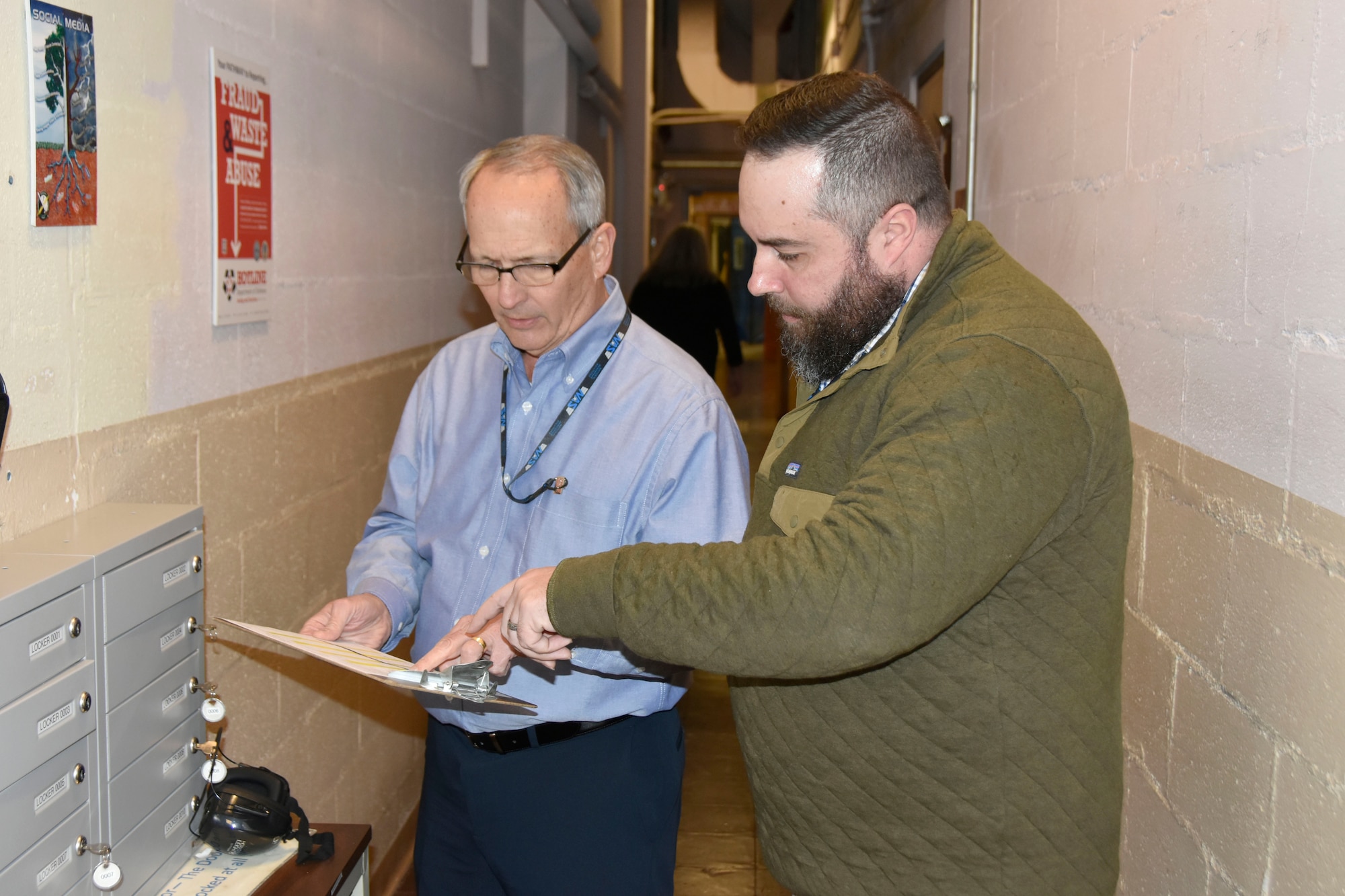 NAS Industrial Security Specialist John Washer, right, and the NAS Deputy General Manager, Mike Belzil, left, conduct Security checks bi-weekly along with Elise Sherrill, NAS Security Manager and Facility Security Officer (not pictured). Belzil is also the NAS Industrial Security Executive Sponsor. (U.S. Air Force photo by Bradley Hicks)