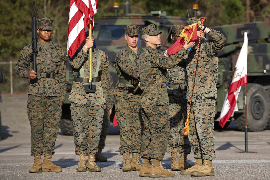 Capt. Kevin Buonomo and 1st Sgt. Adrian Munoz handle the company guidon during Combat Logistics Company 23's realignment ceremony aboard Marine Corps Air Station Beaufort, March 15. Buonomo is the Company Commander and Munoz is the Company 1st Sgt. of CLC-23.