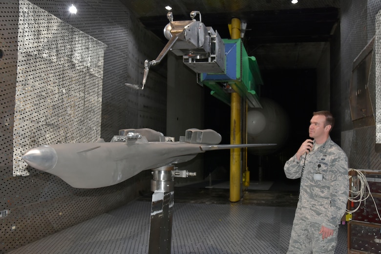 Lt. Johnathan Gutierrez, test manager in the Flight Systems Combined Test Force at Arnold Air Force Base, looks on as a store model performs an offline simulation of store separation from a 10 percent model of the B-1B Lancer. Store separation tests are currently being conducted in the 16-foot transonic wind tunnel at Arnold to assess the impact a newly-introduced targeting pod for the B-1B would have on stores released from the aircraft. (U.S. Air Force photo by Bradley Hicks) (This image was altered by obscuring badges for security purposes)