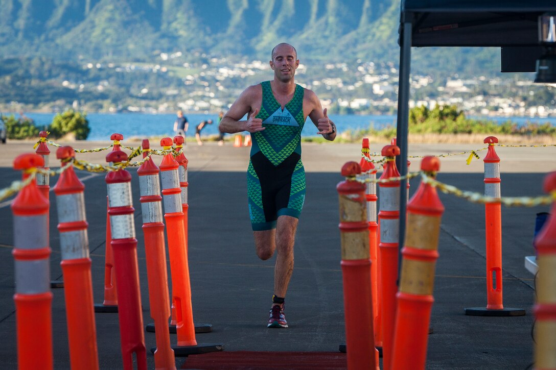 A competitor runs during the Splash and Dash, Marine Corps Base Hawaii, March 16, 2019. The Splash and Dash, hosted by Semper Fit and Helicopter Maritime Strike Squadron 37, invited U.S. Service members, their families, and civilian participants from the local area to swim in Kaneohe Bay and then run on the flightline. (U.S. Marine Corps photo by Cpl. Matthew Kirk)