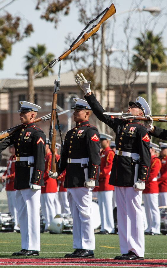 The U.S. Marine Corps Silent Drill Platoon, Battle Color Detachment, Marine Barracks Washington, D.C., performs in front of Marine Corps Air Station Miramar’s leaders, family and friends during the 2019 Battle Color Ceremony at MCAS Miramar, Calif., Mar. 15. The ceremony is held to honor Marine Corps traditions through performances by  “The Commandants Own”, the Silent Drill Platoon and the Battle Colors Detachment as a whole. (U.S. Marine Corps photo by Cpl. Becky Cleveland)