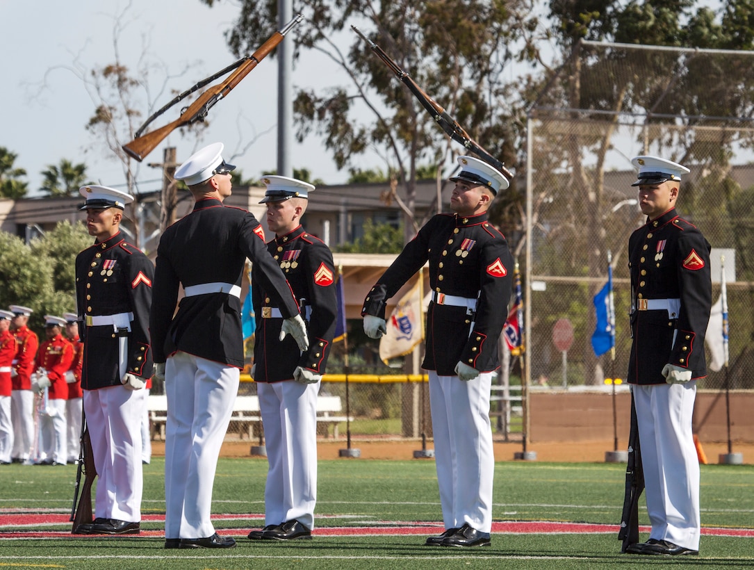 The U.S. Marine Corps Silent Drill Platoon, Battle Color Detachment, Marine Barracks Washington, D.C., performs in front of Marine Corps Air Station Miramar’s leaders, family and friends during the 2019 Battle Color Ceremony at MCAS Miramar, Calif., Mar. 15. The ceremony is held to honor Marine Corps traditions through performances by  “The Commandants Own”, the Silent Drill Platoon and the Battle Colors Detachment as a whole. (U.S. Marine Corps photo by Cpl. Becky Cleveland)