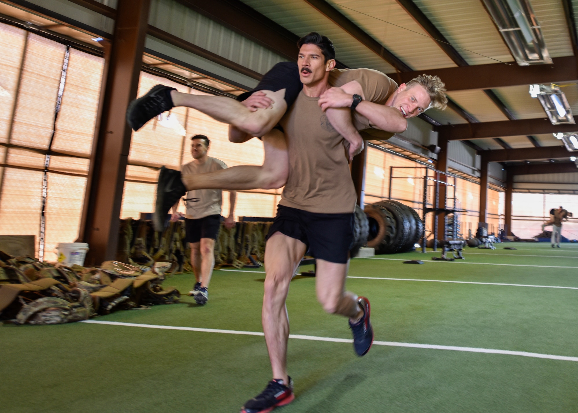 Participants in the Maltz Challenge perform the 100-yard fireman’s carry at Kirtland Air Force Base, N.M., March 15, 2019. This annual event began in 2006 and is held in memory of U.S. Air Force Master Sgt. Michael Maltz, a Pararescueman who was killed in action during a rescue mission in Afghanistan on March 23, 2003. (U.S. Air Force photo by Airman 1st Class Austin J. Prisbrey)