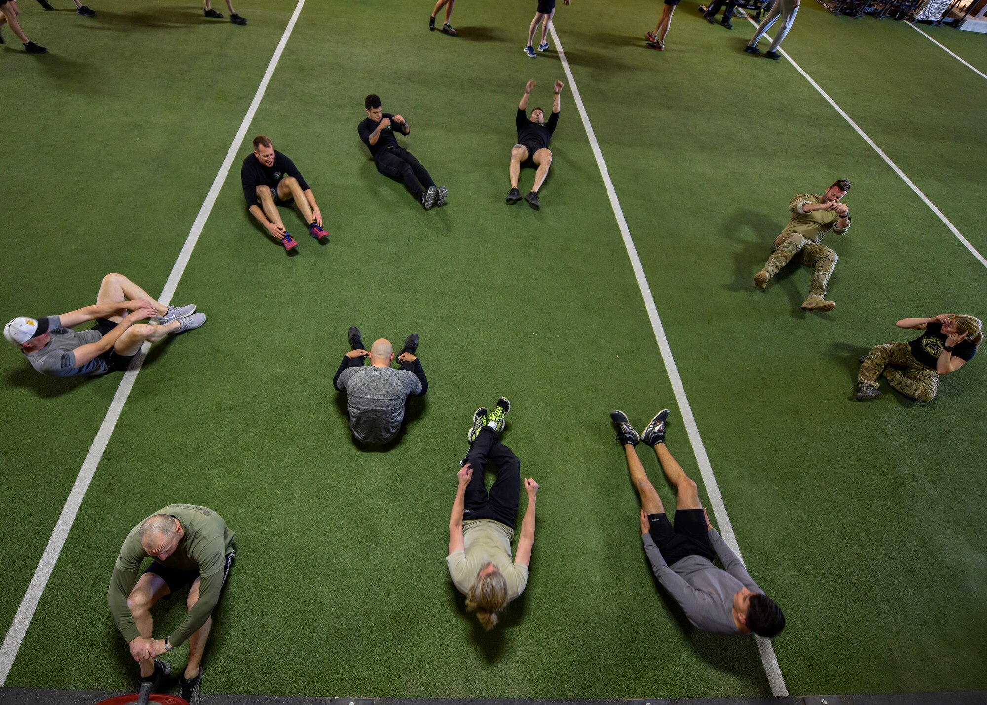 A team participating in the Maltz Challenge perform sit-ups at Kirtland Air Force Base, N.M., March 15, 2019. The Maltz Challenge is a timed, team competition that consists of a 400-meter run, 50 pull-ups, 100 yard fireman’s carry, 50 dips, 100 push-ups, 50 knees-to-elbows, 100 sit-ups and another 400-meter run. (U.S. Air Force photo by Airman 1st Class Austin J. Prisbrey)