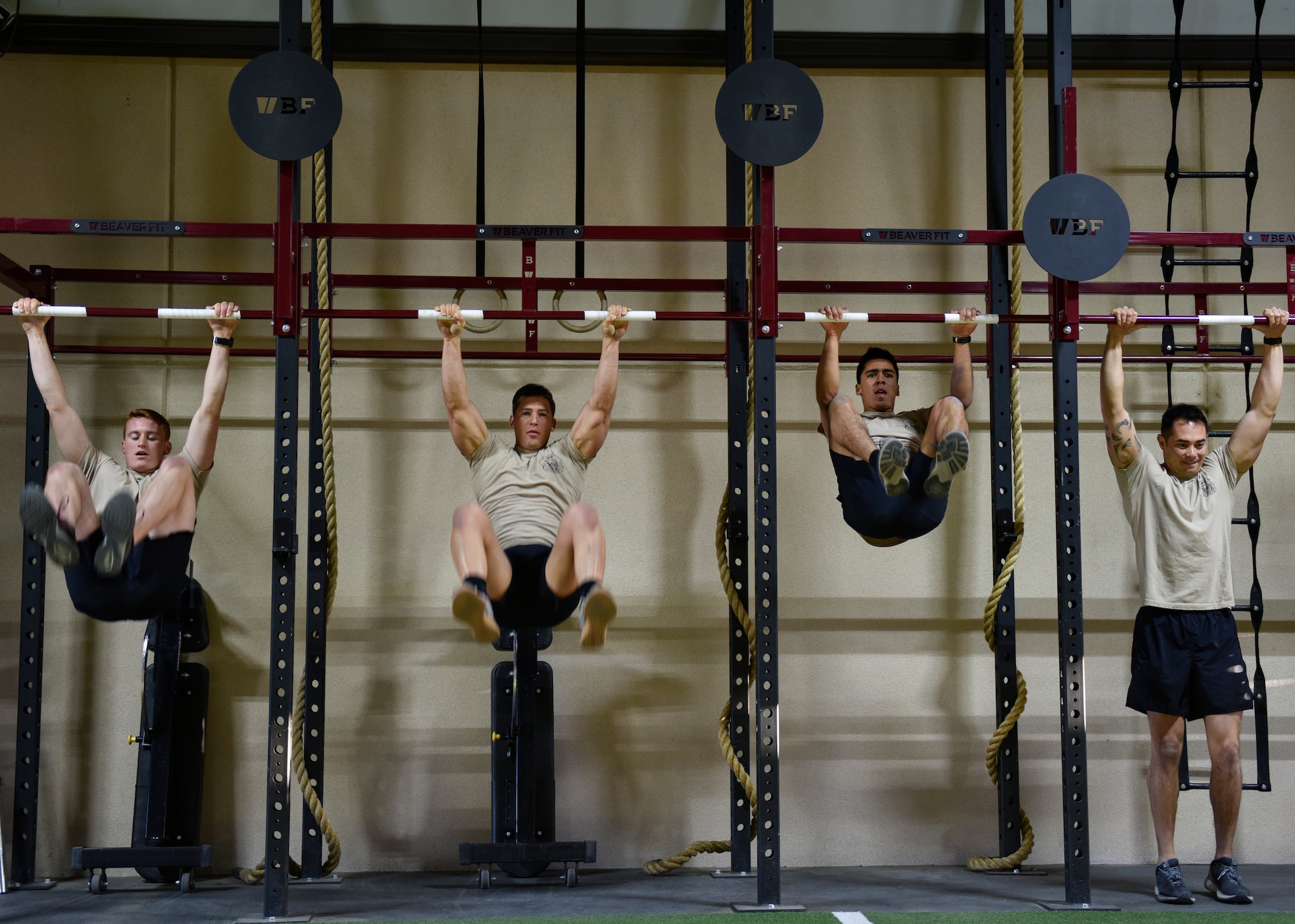 Participants in the Maltz Challenge perform the knees to elbows exercise at Kirtland Air Force Base, N.M., March 15, 2019. The Maltz Challenge is a timed, team competition that consists of a 400-meter run, 50 pull-ups, 100 yard fireman’s carry, 50 dips, 100 push-ups, 50 knees-to-elbows, 100 sit-ups and another 400-meter run. (U.S. Air Force photo by Airman 1st Class Austin J. Prisbrey)