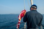Phuket, Thailand (March 18, 2019) Boatswain’s Mate 3rd Class Xiao Wang, from San Francisco, prepares to raise the first Navy jack prior to anchoring off the coast of Phuket, Thailand during sea and anchor detail aboard the Arleigh Burke-class guided-missile destroyer USS Preble (DDG 88). Preble is visiting Phuket for a regular scheduled port visit. Preble is deployed to the U.S 7th Fleet area of operations in support of security and stability in the Indo-Pacific region.
