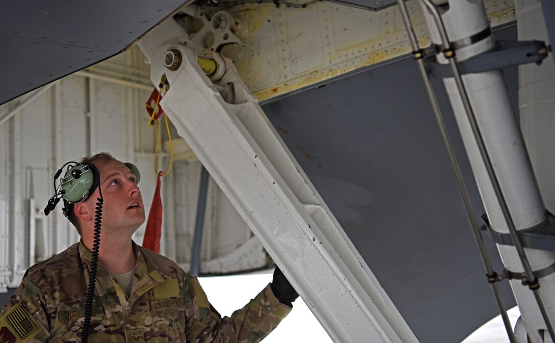 U.S. Air Force Staff Sgt. Shannon Nations, 100th Aircraft Maintenance Squadron flying crew chief, inspects landing gear of a KC-135 Stratotanker from RAF Mildenhall after landing in Bucharest for refueling training with Romanian air force F-16s in Bucharest, Romania, March 11, 2019. The crew was involved in training over the skies of Romania, which enhanced regional capabilities to secure air sovereignty and promote peace and security through cooperation, collaboration, interoperability with NATO allies in the region. (U.S. Air Force photo by Airman 1st Class Brandon Esau)