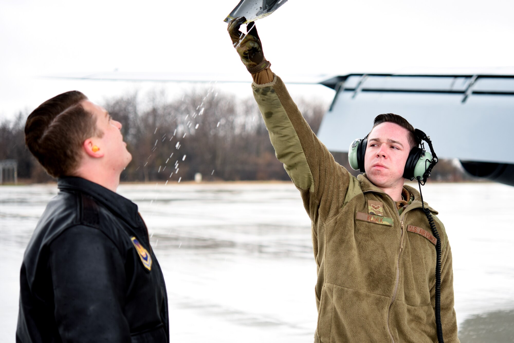 U.S. Air Force Capt. Logan Dean, 351st Air Refueling Squadron pilot, and U.S. Air Force Senior Airman Christian Klimek, 100th Aircraft Maintenance Squadron flying crew chief, conduct a walk-around prior to take-off for refueling training with Romanian air force F-16s in Bucharest, Romania, March 12, 2019. The training was an example of U.S. and NATO allies sharing a commitment to promote peace and stability through developing their relationship and communication process. (U.S. Air Force photo by Airman 1st Class Brandon Esau)