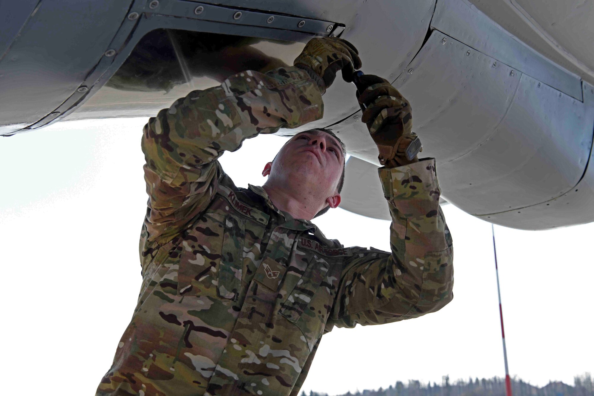 U.S. Air Force Senior Airman Christian Klimek, 100th Aircraft Maintenance Squadron flying crew chief, preps the boom operator pod prior to take-off for refueling training with Romanian air force F-16s in Bucharest, Romania, March 13, 2019. The training was an example of U.S. and NATO allies sharing a commitment to promote peace and stability through developing their relationship and communication process. (U.S. Air Force photo by Airman 1st Class Brandon Esau)