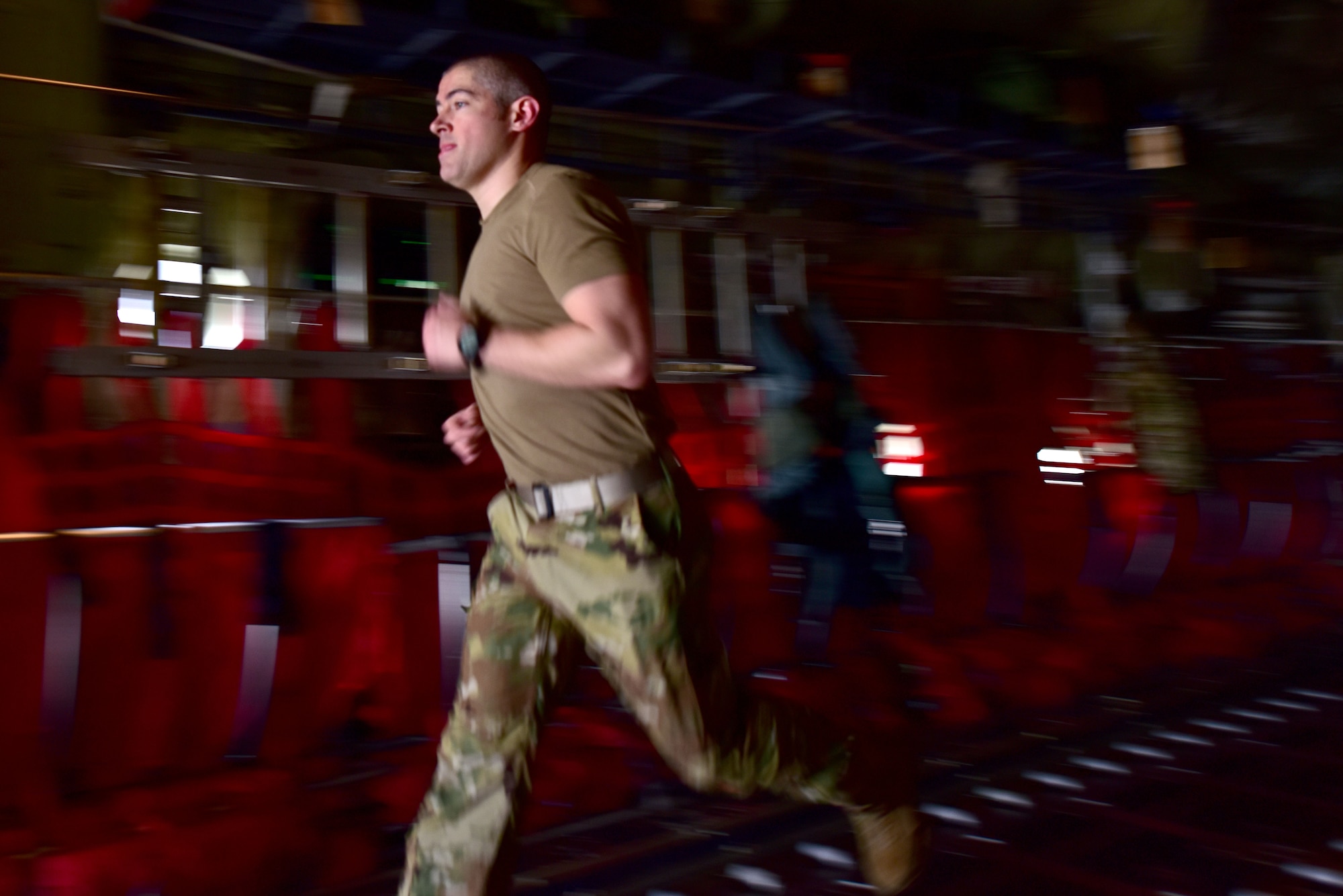 An Airman runs on board a C-130J.