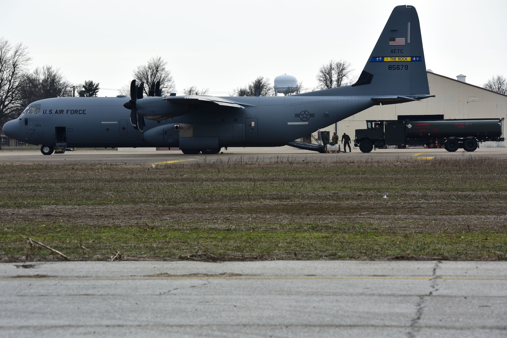 A fuel truck gets onloaded to a C-130J.