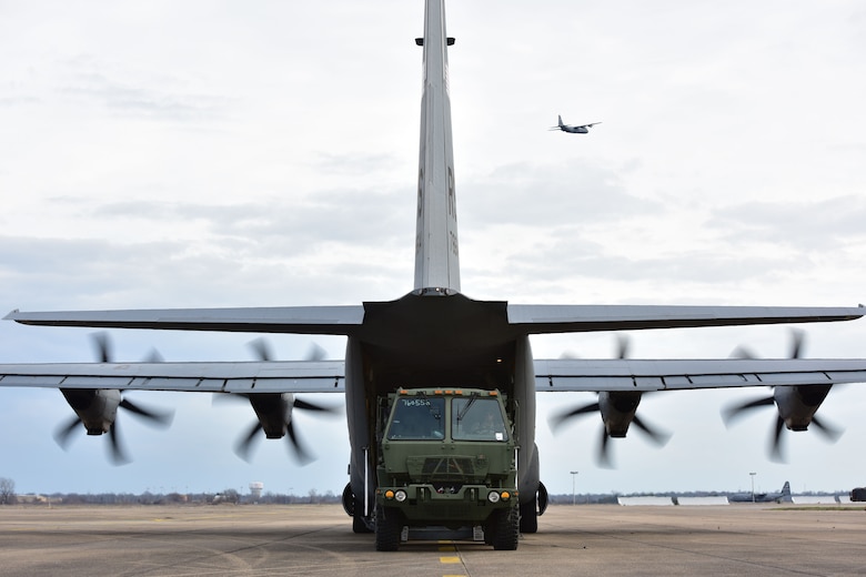 A vehicle gets onloaded to a C-130J.
