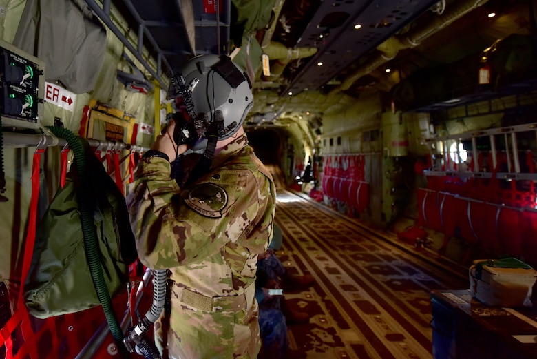 An Airman puts on his flight helmet.
