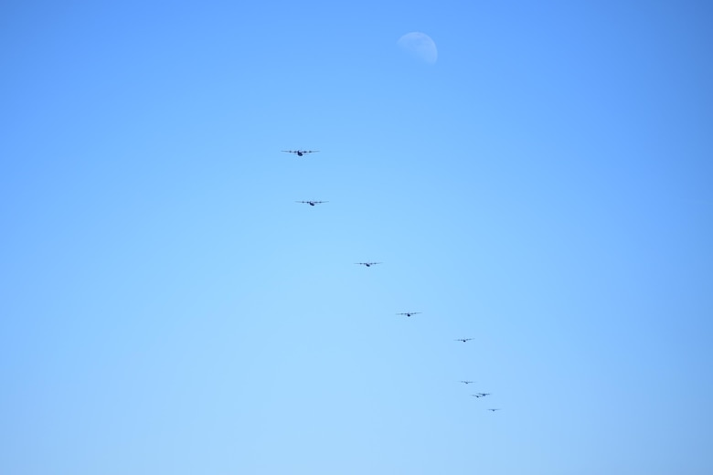 Many C-130Js fly in formation.
