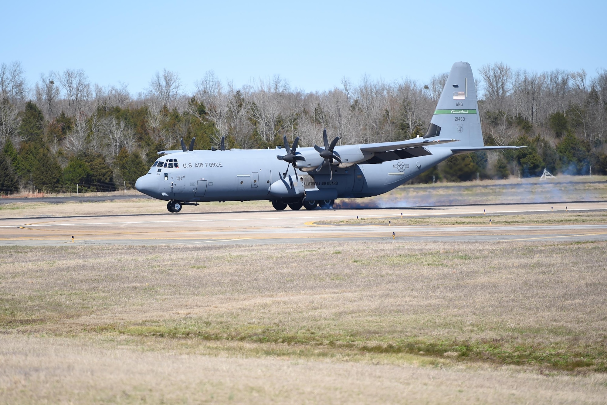 A C-130J is taxiing on a runway.