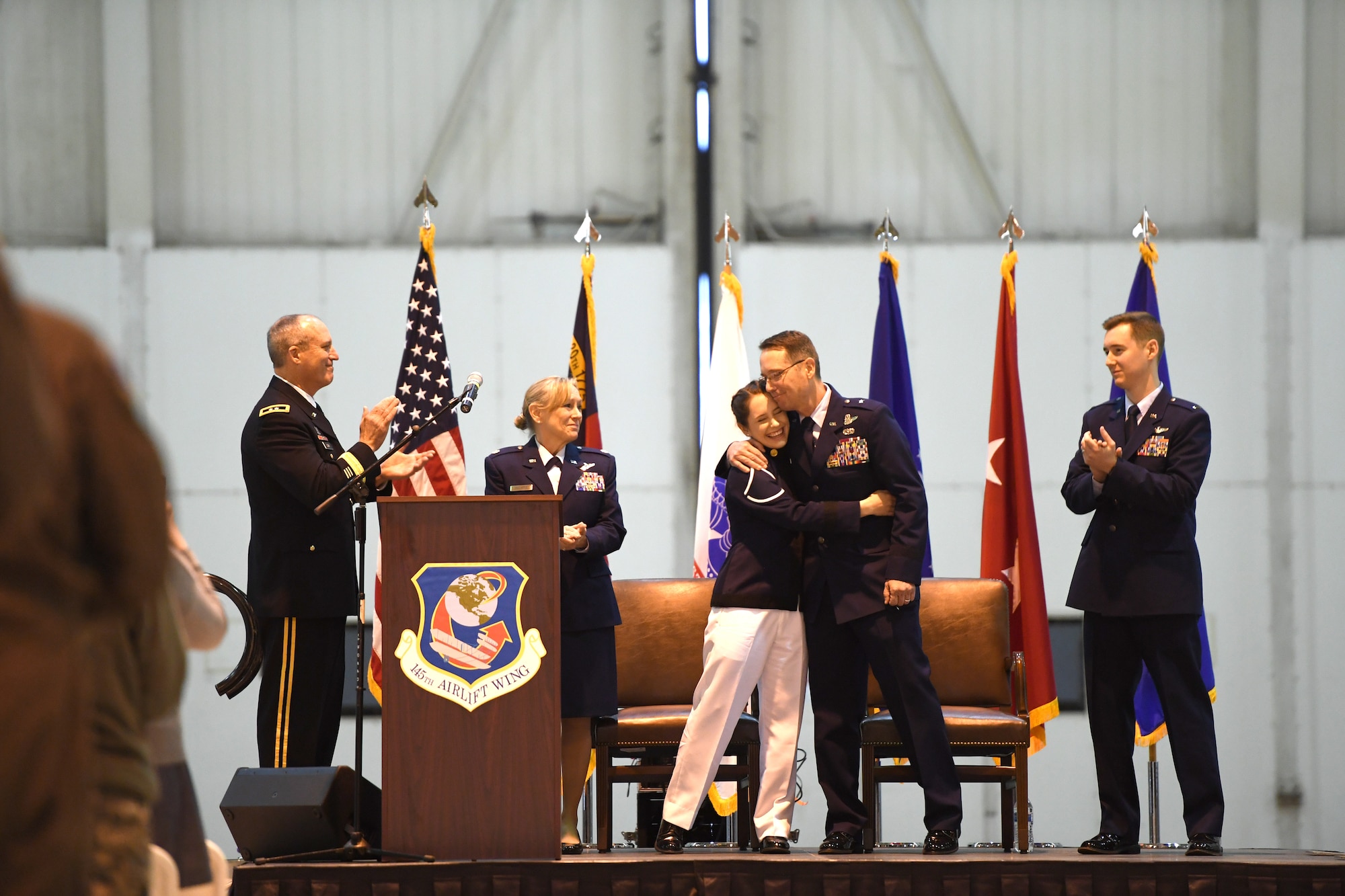 U.S. Air Force Brig. Gen. Stephen J. Mallette, director of cyberspace operations for Joint Force Headquarters, North Carolina (NC) National Guard Bureau, hugs his daughter, Melanie, during his promotion ceremony at the NC Air National Guard Base, Charlotte Douglas International Airport, Mar. 09, 2019. Family, friends, and guard members gather to watch Col. Mallette pin on the rank of Brig. Gen. He has has served for 37 years including enlisted time in the Army and Air Force.