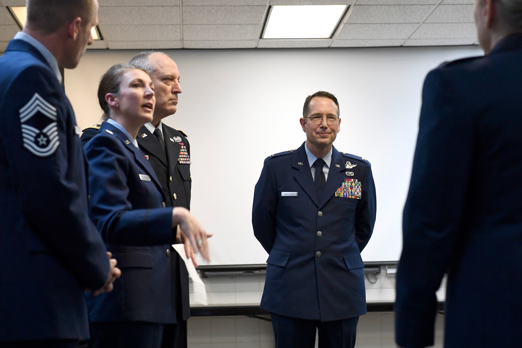 U.S. Air Force Col. Stephen J. Mallette (center), director of cyberspace operations for Joint Force Headquarters, North Carolina (NC) National Guard Bureau, visits with friends and readies himself prior to the start of his promotion ceremony at the NC Air National Guard Base, Charlotte Douglas International Airport, Mar. 09, 2019. Family, friends, and guard members gather to watch Col. Mallette pin on the rank of Brig. Gen. He has has served for 37 years including enlisted time in the Army and Air Force.