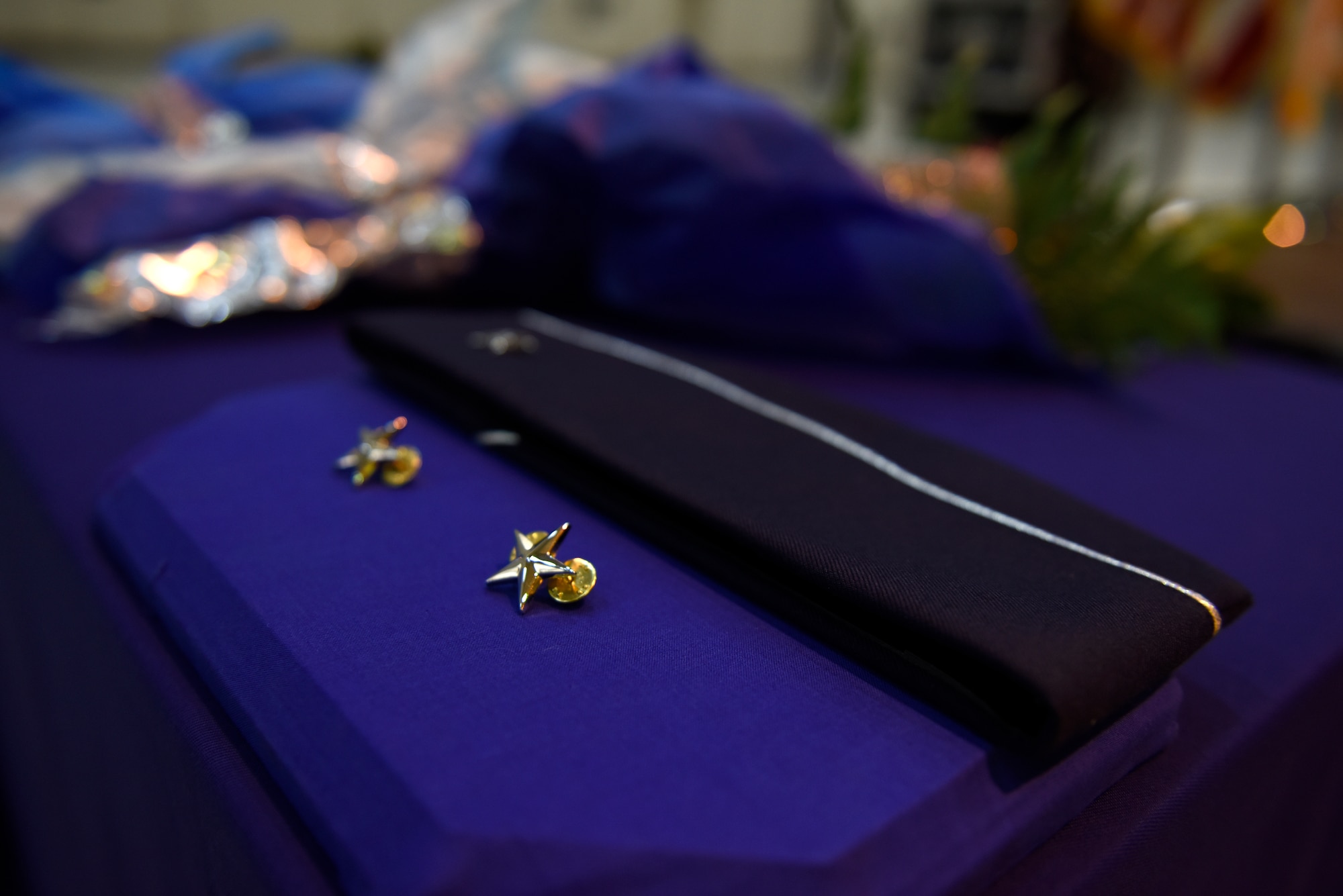 U.S. Air Force Col. Stephen J. Mallette, director of cyberspace operations for Joint Force Headquarters, North Carolina (NC) National Guard Bureau, has his hat and pins laid out decoratively prior to the start of his promotion ceremony at the NC Air National Guard Base, Charlotte Douglas International Airport, Mar. 09, 2019. Family, friends, and guard members gather to watch Col. Mallette pin on the rank of Brig. Gen. He has has served for 37 years including enlisted time in the Army and Air Force.
