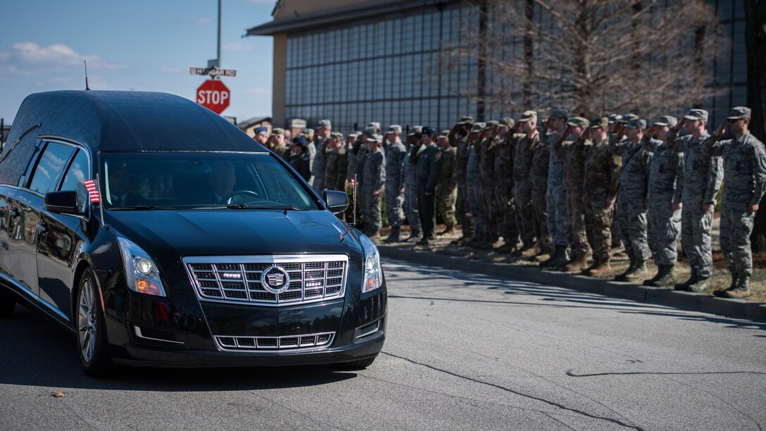 U.S. Air Force citizen Airmen and civilians from the 932nd Airlift Wing stand with Team Scott Mar. 18, 2019, Scott Air Force Base, Illinois, to show respect for the Dignified Transfer of Army Sgt. Holli R. Bolinski, of Pinckneyville, Illinois.  She was killed, along with another soldier in her unit, Spc. Jackson Johnson, of Hillsboro, Missouri, in a non-combat vehicle crash on Mar. 5, 2019, while serving during Operation Inherent Resolve. Bolinski and Johnson were both assigned to the Army Reserve unit 635th Transportation Company, 419th Transportation Battalion, 103rd Sustainment Command, Mount Vernon, Illinois. (U.S. Air Force photo by Christopher Parr)