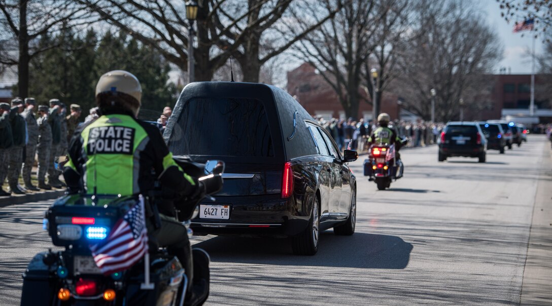 U.S. Air Force citizen Airmen and civilians from the 932nd Airlift Wing stand with Team Scott Mar. 18, 2019, Scott Air Force Base, Illinois, to show respect for the Dignified Transfer of Army Sgt. Holli R. Bolinski, of Pinckneyville, Illinois.  She was killed, along with another soldier in her unit, Spc. Jackson Johnson, of Hillsboro, Missouri, in a non-combat vehicle crash on Mar. 5, 2019, while serving during Operation Inherent Resolve. Bolinski and Johnson were both assigned to the Army Reserve unit 635th Transportation Company, 419th Transportation Battalion, 103rd Sustainment Command, Mount Vernon, Illinois. (U.S. Air Force photo by Christopher Parr)