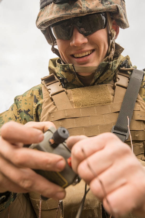 U.S. Marine Corps Cpl. Evan Sherling, a field artillery radar operator with Headquarters Battery, 14th Marine Regiment, 4th Marine Division, attaches wires to a firing device at a demo range at Adazi Training Area, Latvia, March 8, 2019, during exercise Dynamic Front 19. Exercise Dynamic Front 19 includes approximately 3,200 service members from 27 nations who are observing or participating from Grafenwoehr Training Area, Germany; Riga, Latvia; and Torun, Poland; during March 2-9, 2019. Dynamic Front is an annual U.S. Army Europe exercise focused on the readiness and interoperability of U.S. Army, joint service, and allied and partner nations’ artillery and fire support working together in a multinational environment. (U.S. Marine Corps photo by Cpl. Niles Lee)