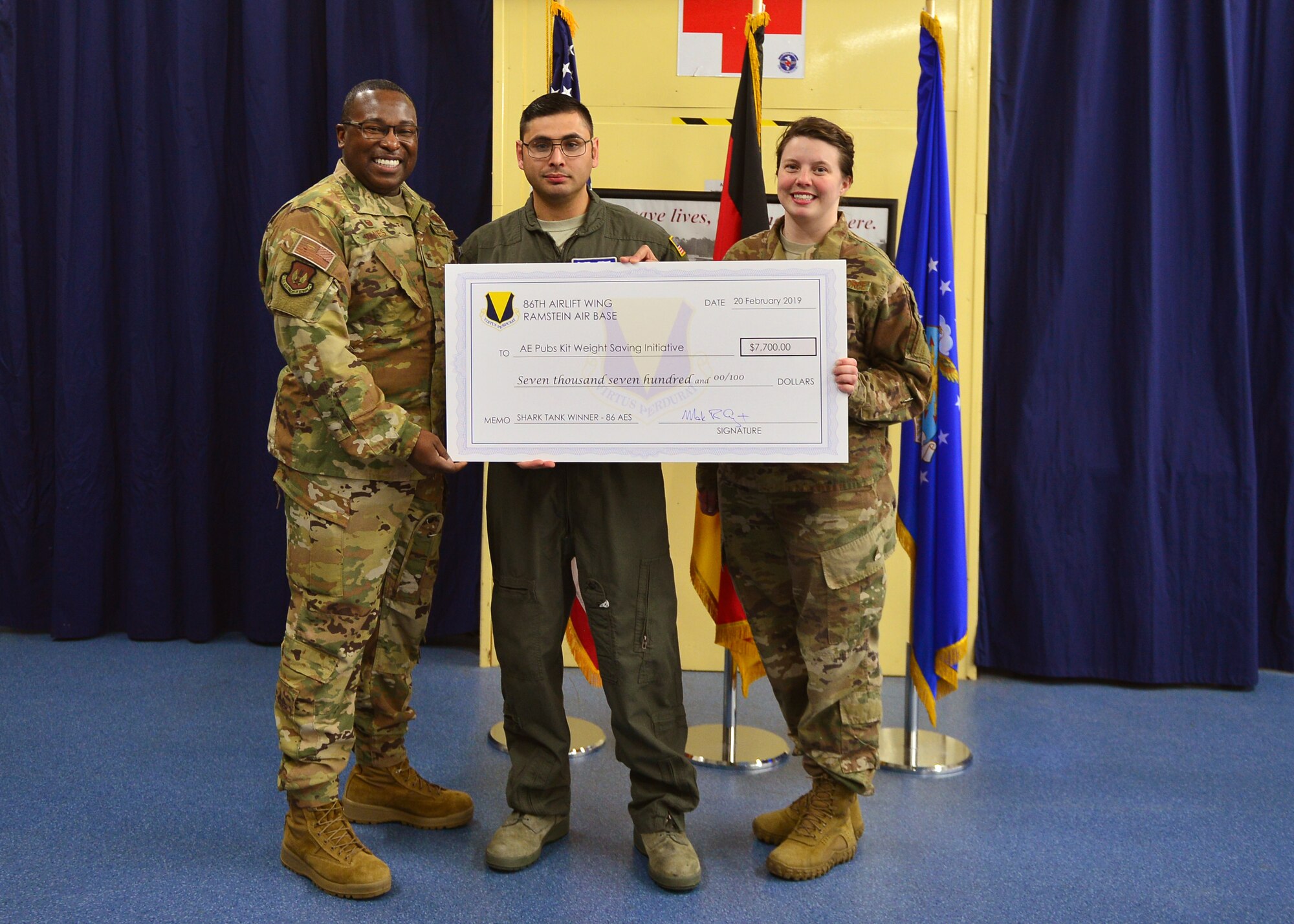From left to right, U.S. Air Force Col. Ronald Jones, 86th Aeromedical Evacuation Squadron commander, Staff Sgt. Devon Bernal, 86th AES aeromedical evacuation technician, and Staff Sgt. Courtney Fitzpatrick, 86th AES logistician, show off a check awarded to their team at Ramstein Air Base, Germany, March 11, 2019.