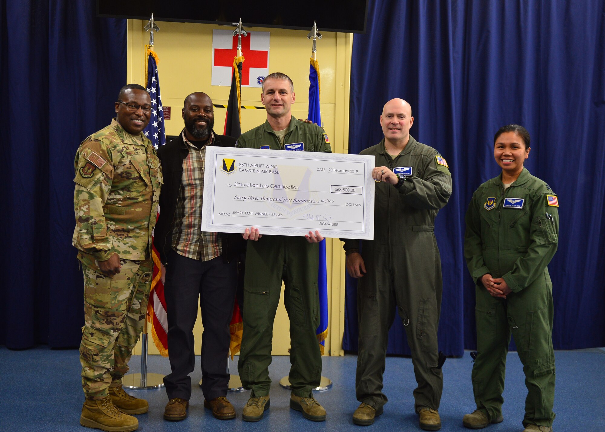 From left to right, U.S. Air Force Col. Ronald Jones, 86th Aeromedical Evacuation Squadron commander, Ali Rivers, 86th AES clinical simulation operator, Maj. Jeremy Hicks, 86th AES clinical nurse specialist, Capt. Jamison Krahenbuhl, 86th AES simulation technology officer, and Capt. Jewelyn De La Cruz, 86th AES simulation technology element leader, show off a check awarded to their team at Ramstein Air Base, Germany, March 11, 2019.