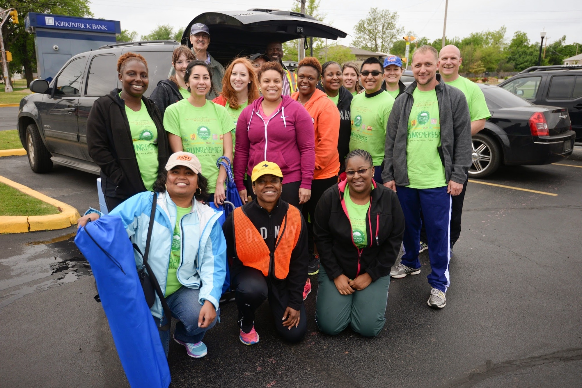 Chief Master Sgt. Takesha Williams, 507th Air Refueling Wing budget analyst, 931st ARW command chief and Reserve course marshal for the Oklahoma City Memorial Marathon, kneels in an orange vest for a photograph with other course marshal volunteers April 26, 2015, in Oklahoma City, Oklahoma. For more than a decade, Williams has been responsible for gathering Reserve volunteers to help manage the course during the marathon. (U.S. Air Force courtesy photo)
