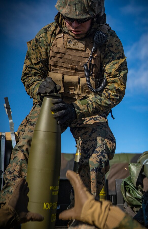 A U.S. Marine with Hotel Battery, 3rd Battalion, 14th Marine Regiment, 4th Marine Division, passes a M795 155mm projectile to another Marine at Adazi Training Area, Latvia, March 2, 2019, in support of exercise Dynamic Front 19. DF19 will provide an intense, realistic environment that takes advantage of U.S. Army Europe’s unique training resources to seamlessly coordinate fires in support of U.S. and Allied operations. Approximately 3,200 participants from 27 nations will take part in the live-fire portion of exercise Dynamic Front 19, March 2-9, 2019, at the U.S. Army's Grafenwoehr Training Area, Germany; as well as in Riga, Latvia; and Torun, Poland. (U.S. Marine Corps photo by Sgt. Andy O. Martinez)