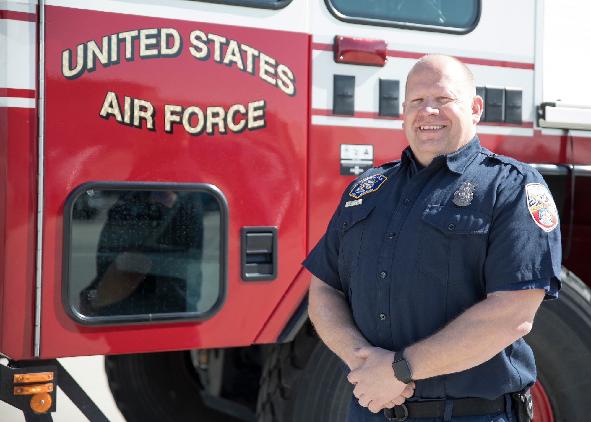 Firefighter Russell Pressley, a driver/operator with the Roland R. Wright Fire Department stands beside a Oshkosk “Striker” Fire Fighting truck March 11, 2019 at Roland R. Wright Air National Guard Base, Salt Lake City, Utah. Pressley responded to a tanker truck fire in Salt Lake City on February 22, 2019 and was able to assist local fire fighters with the specialized truck